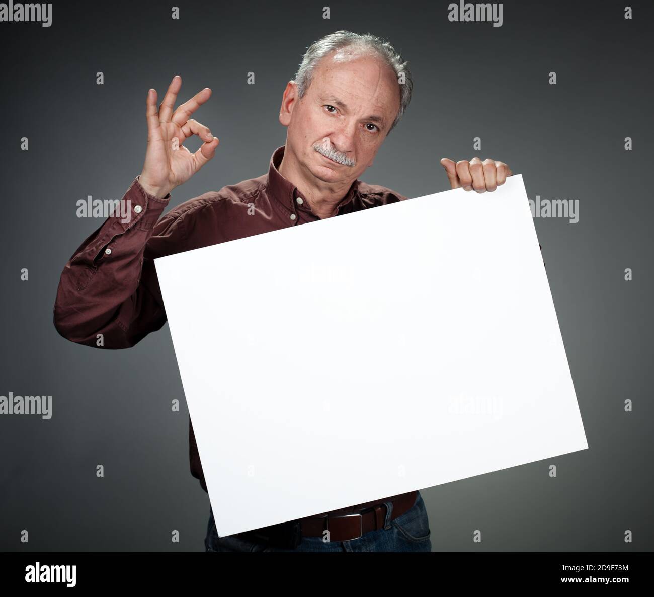 Portrait of a retired old man holding empty bill board Stock Photo