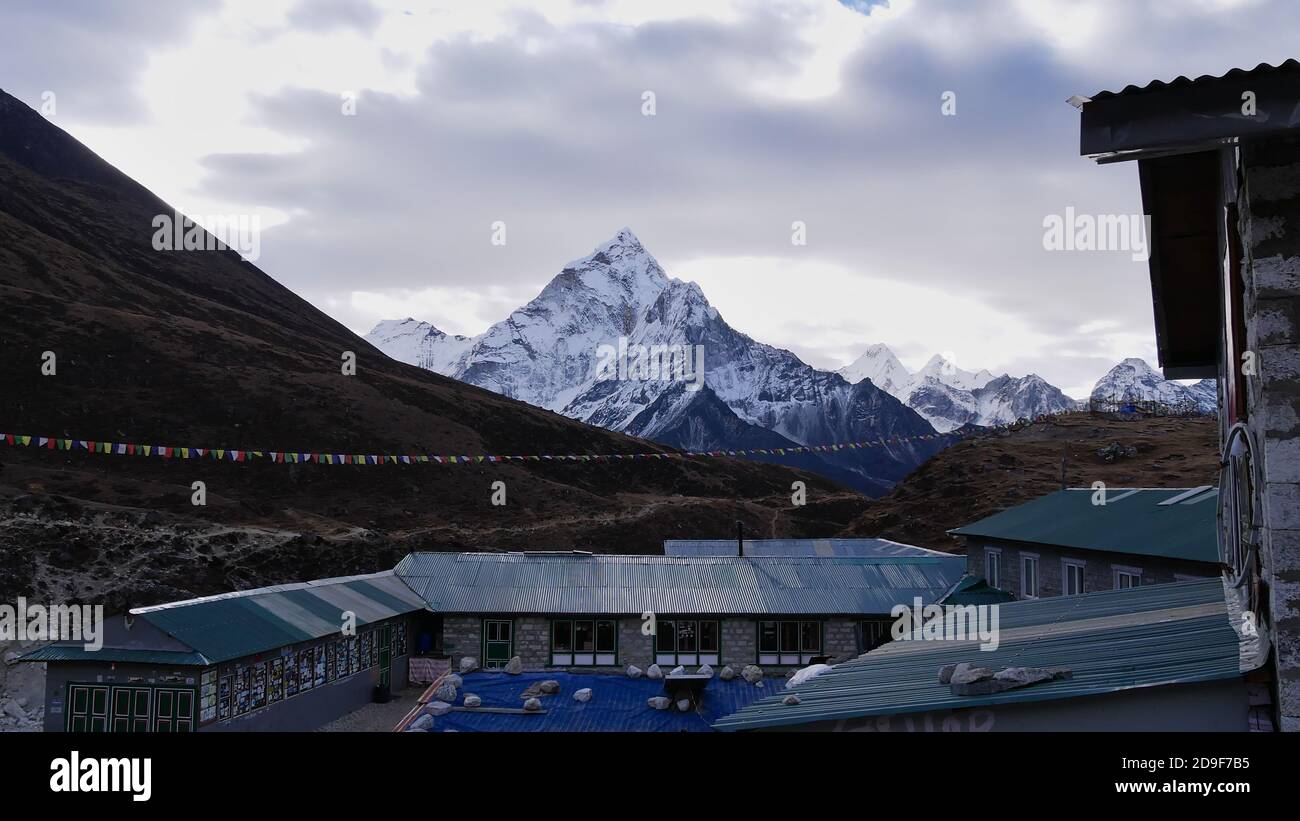 Sherpa lodges with corrugated iron roofs in small village Dughla (Thukla) on Everest Base Camp Trek in the morning light in the Himalayas, Nepal. Stock Photo