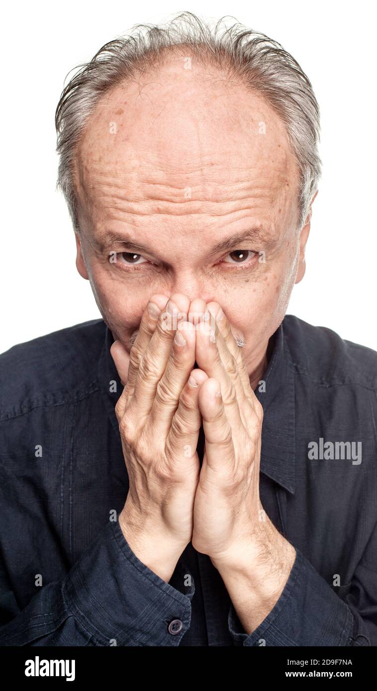 Elderly man covers his face with hand Stock Photo - Alamy