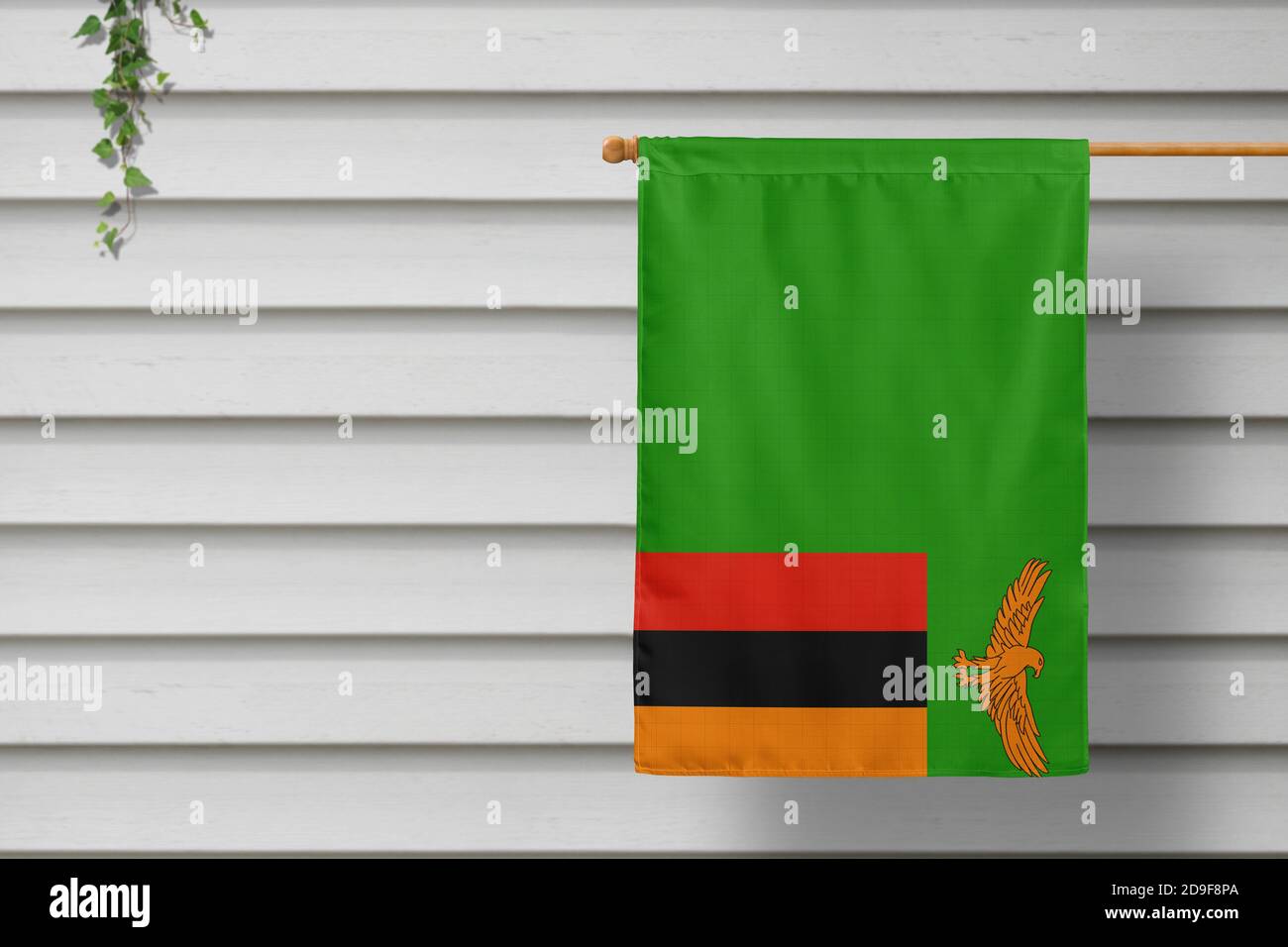 Zambia national small flag hangs from a picket fence along the wooden