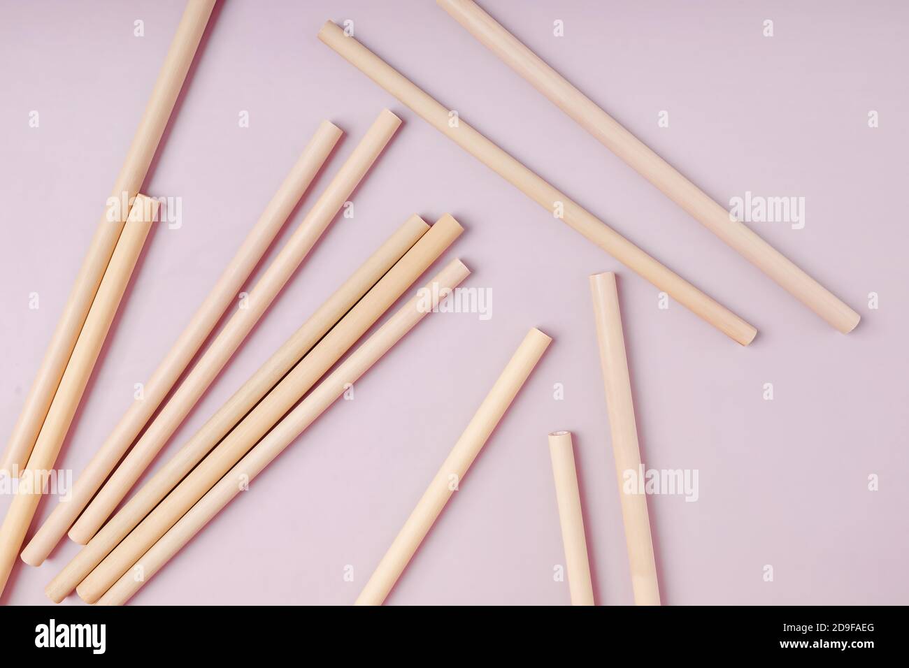 Bamboo straws straws on pink background. Stock Photo