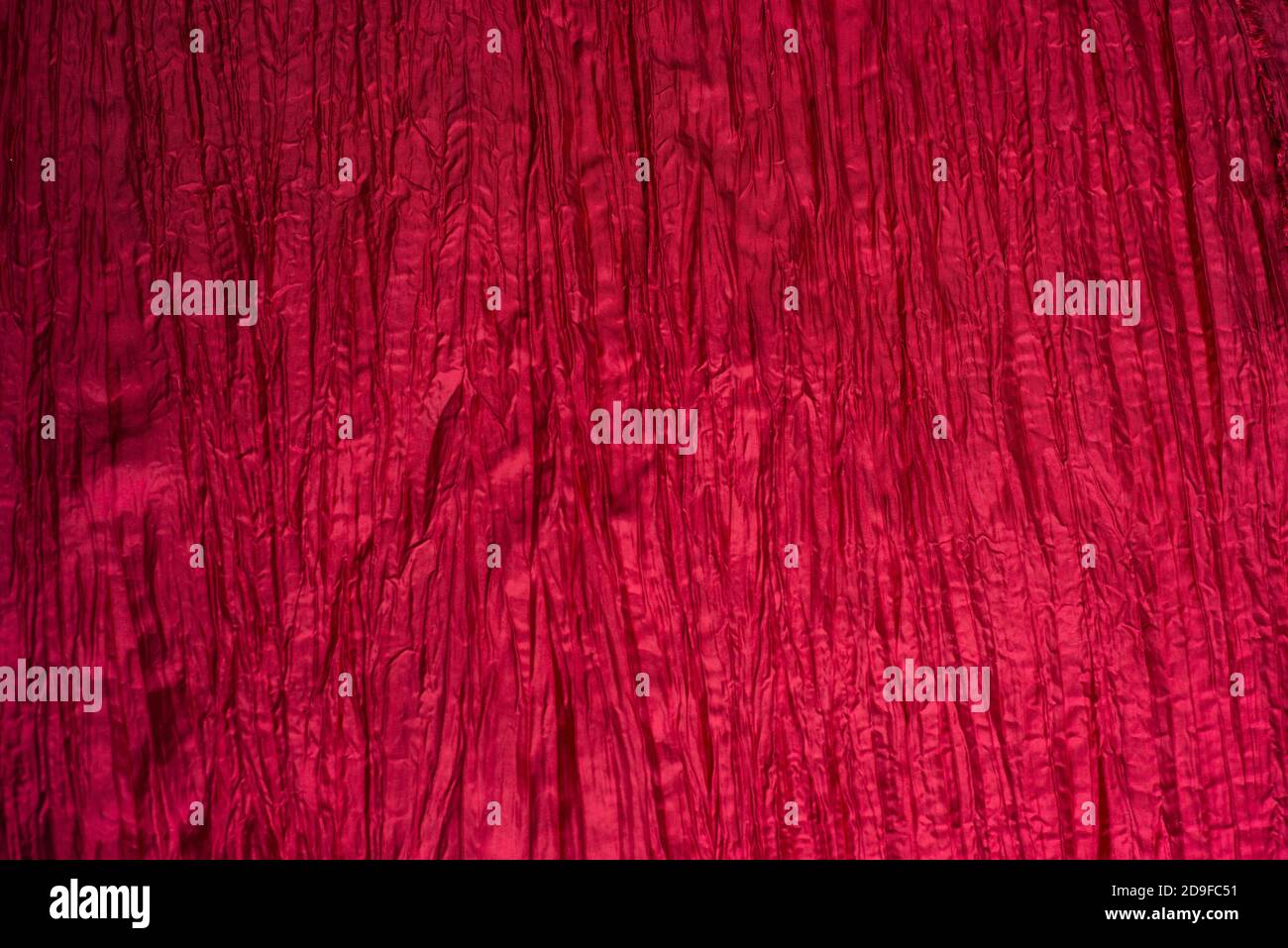 Red wrinkled taffeta background. Crumpled texture. Stock Photo