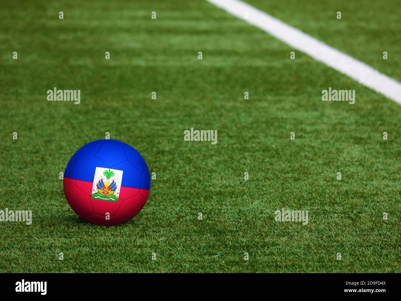 Haiti flag on ball at soccer field background. National football theme