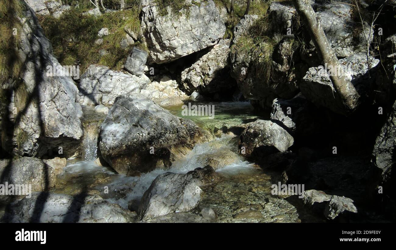 Watercourse in the dolomites with water and rocks Stock Photo