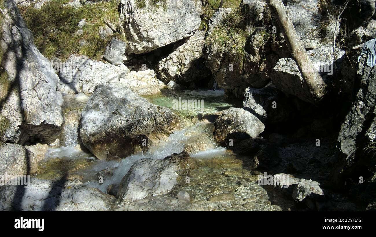 Watercourse in the dolomites with water and rocks Stock Photo