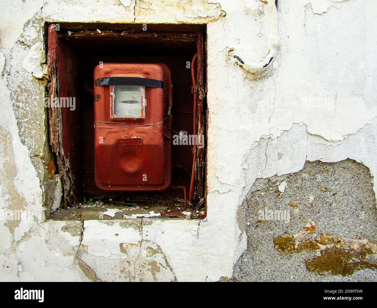 Old Electricity Meter on Deserted House Wall, Galatas Village, Crete, Greece Stock Photo
