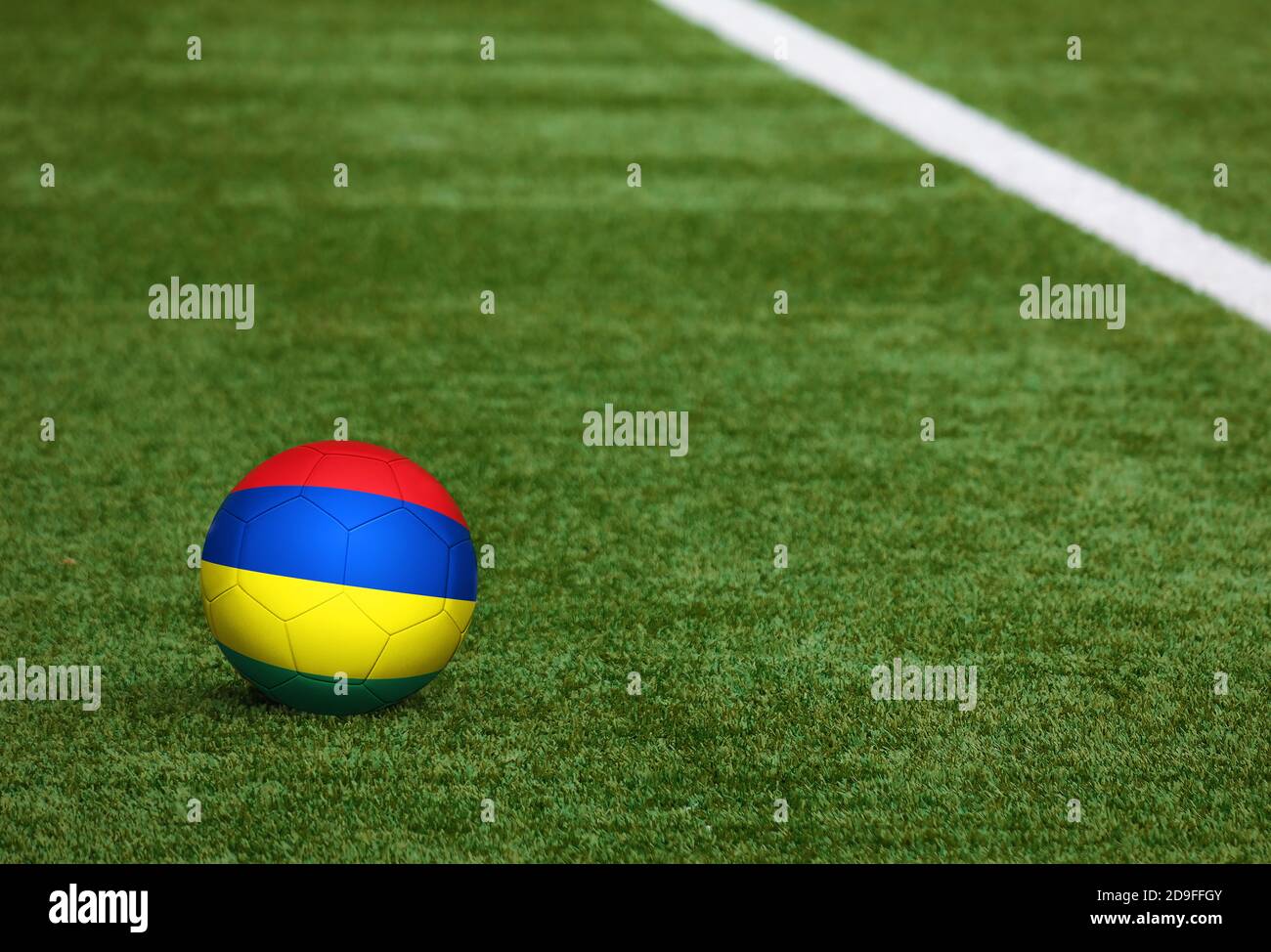 Mauritius flag on ball at soccer field background. National football