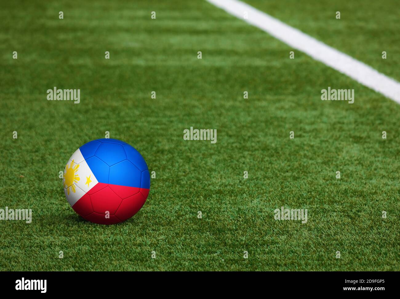 Philippines flag on ball at soccer field background. National football