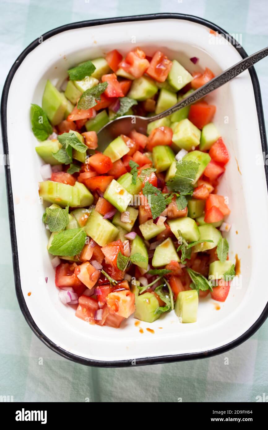 Tomato, cucumber, red onion salad with mint and balsamic vinegar Stock
