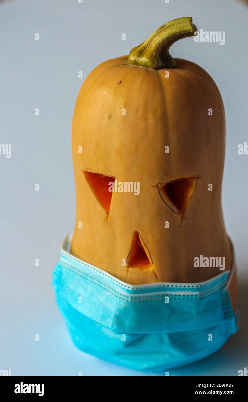Halloween pumpkin wearing mask  and maintaining safety Stock Photo