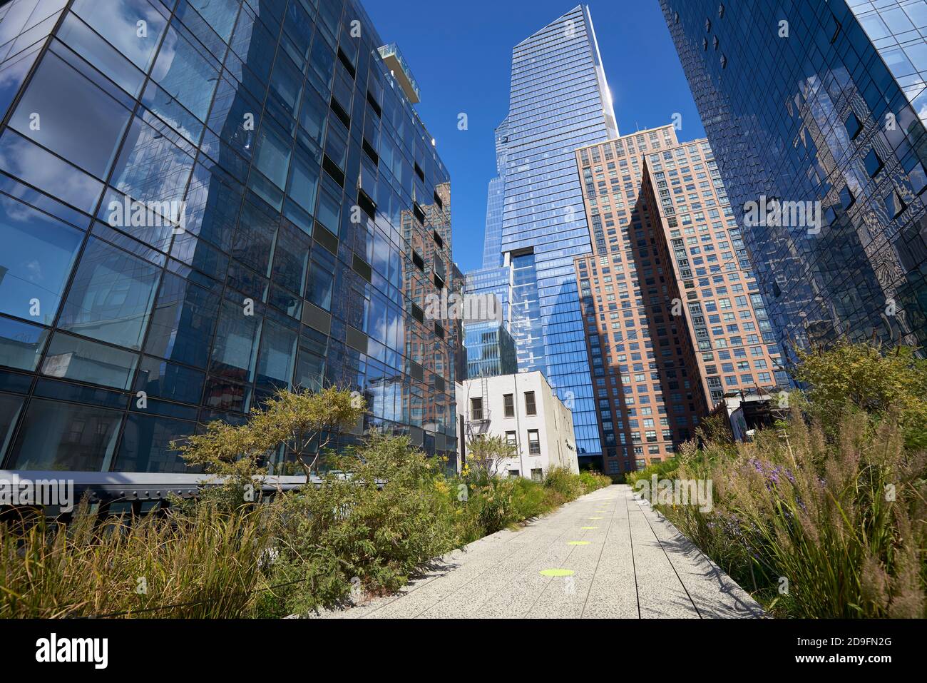 Walkway flanked with buildings in The High Line Park in New York City Stock Photo
