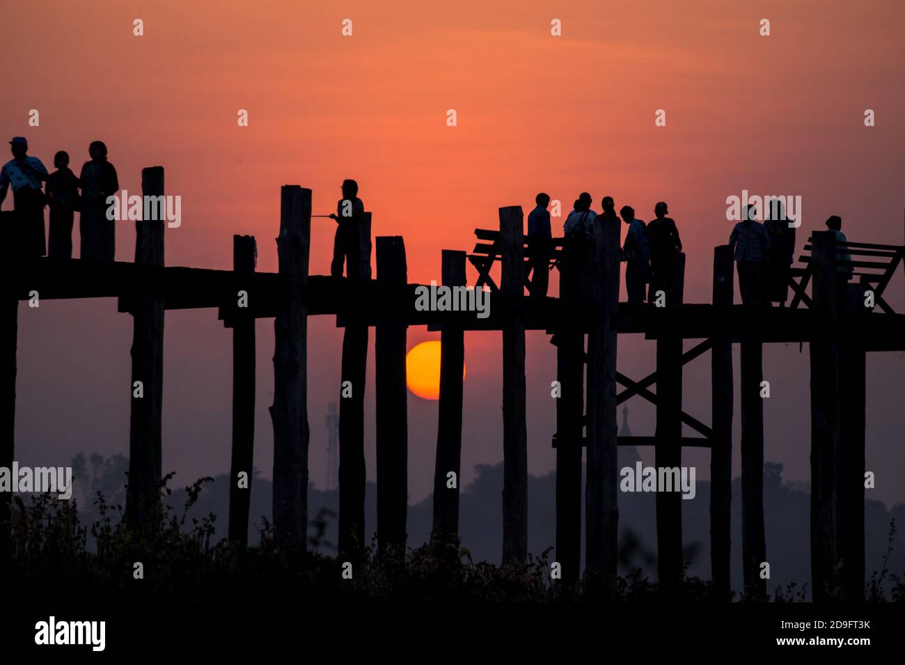 silhouette of people walking on a bridge at sunset Stock Photo - Alamy