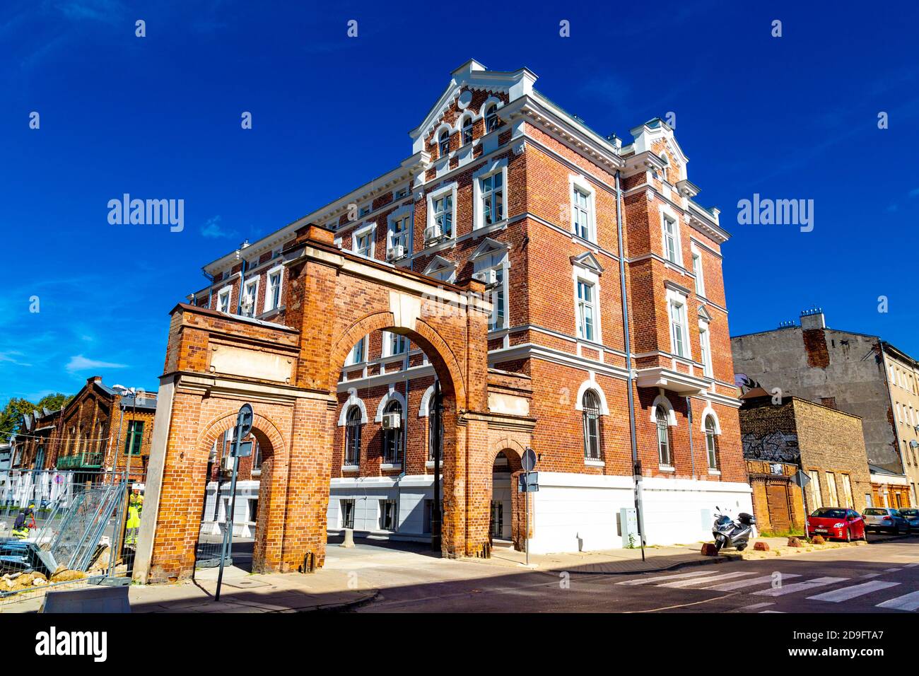 Red brick arch entrance to regenerated Soho Factory in the Praga district of Warsaw, Poland Stock Photo