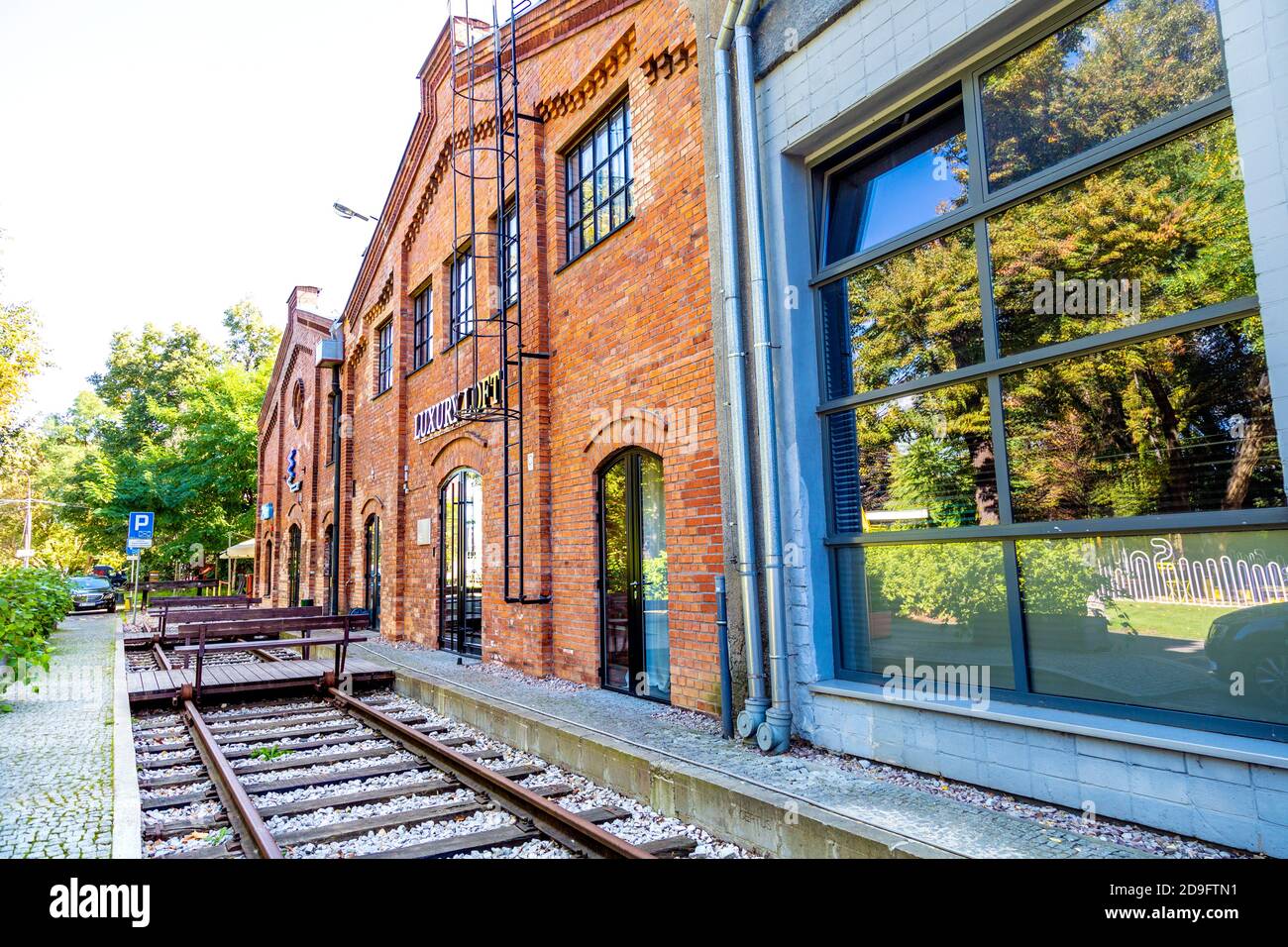 Red brick industrial buildings and train tracks in regenerated Soho Factory in the Praga district of Warsaw; Poland Stock Photo