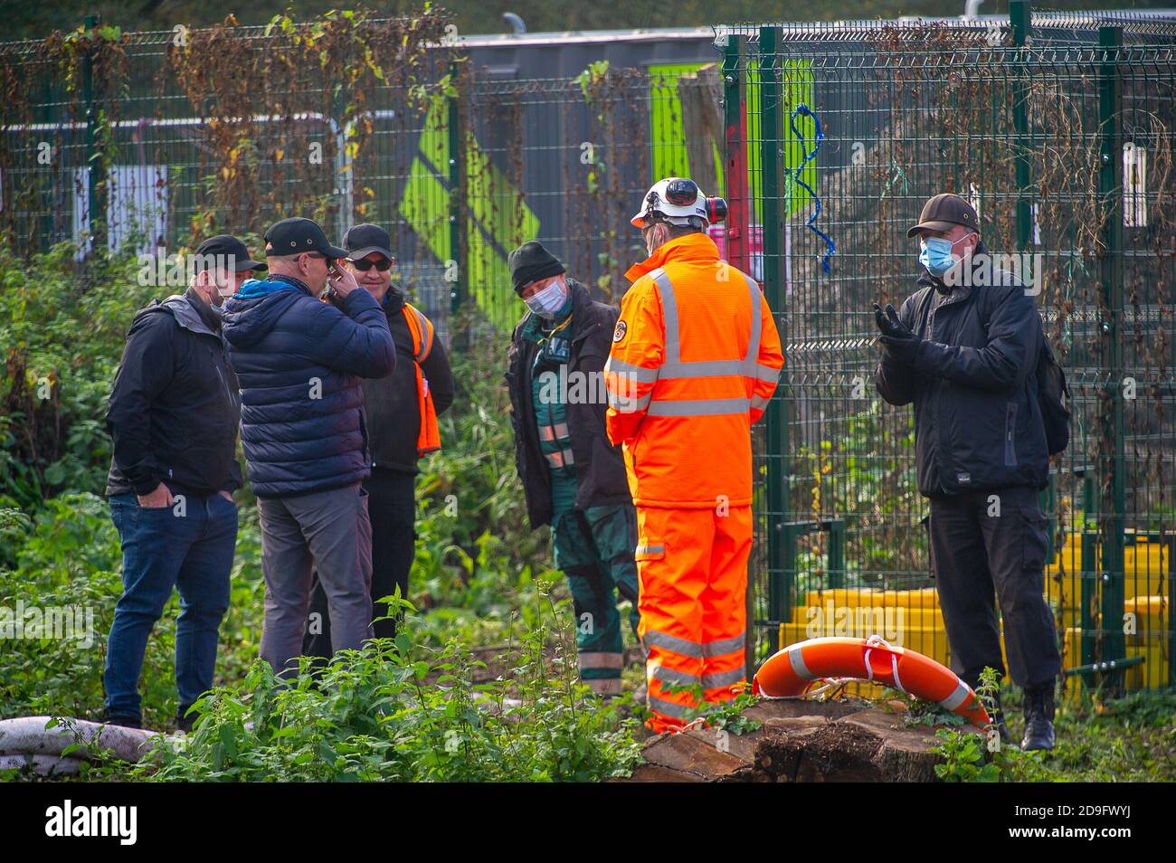 Denham, Buckinghamshire, UK. 5th November, 2020. HS2 staff ignore social distancing. Despite England now being in a Covid-19 national lockdown for the second time, HS2 are being allowed to continue with their construction work for the new High Speed rail from London to Birmingham. Concrete was being pumped into the foundations for a new HS2 bridge across the chalk stream River Colne in Denham Country Park today. Credit: Maureen McLean/Alamy Live News Stock Photo