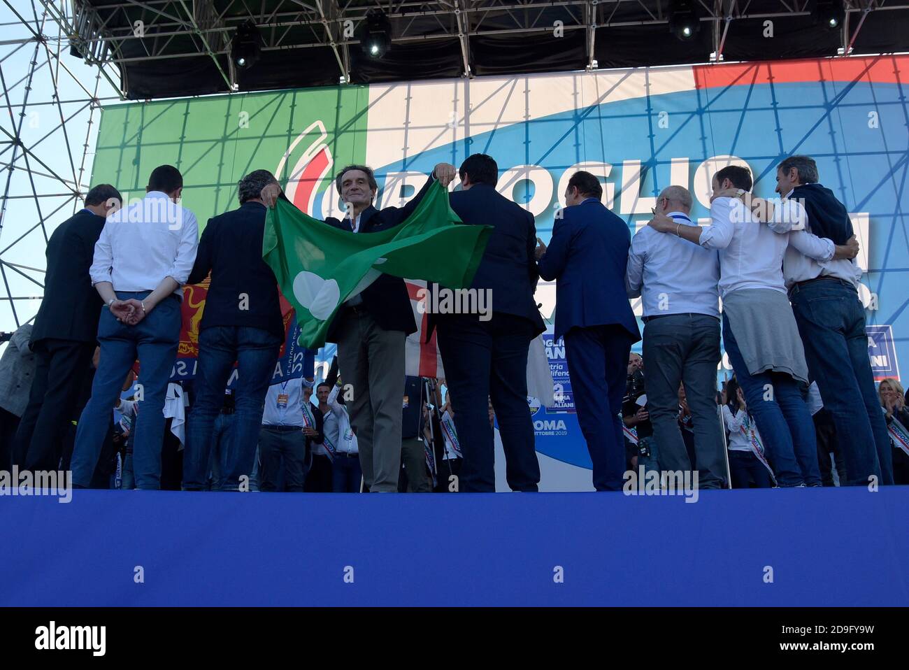 Presidents of Regions governed by right-wing parties, with the president of the Lombardy Region, Attilio Fontana waving the flag of Lombardy during the 'Italian Pride' event at Piazza San Giovanni which brings together the Italian right-wing parties, Lega, Fratelli d'Italia and Forza Italia. Stock Photo