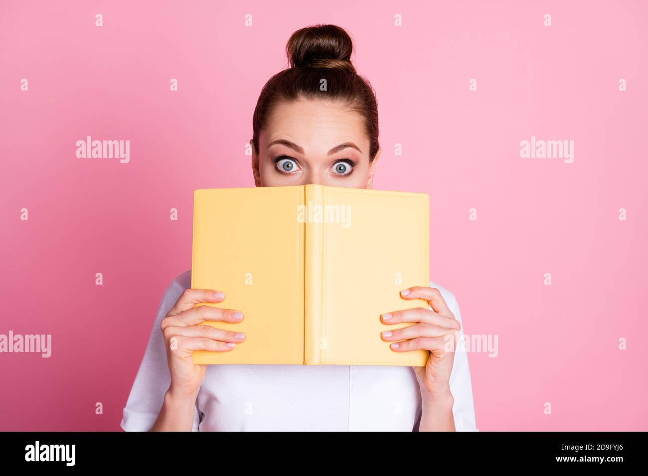 Photo of astonished girl read novel book impressed close cover