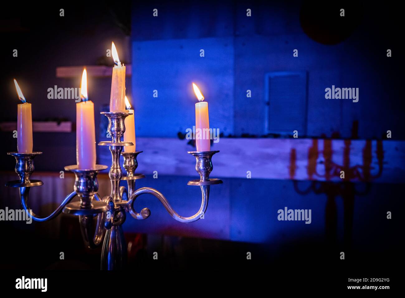 candles burning with blue background light Stock Photo - Alamy