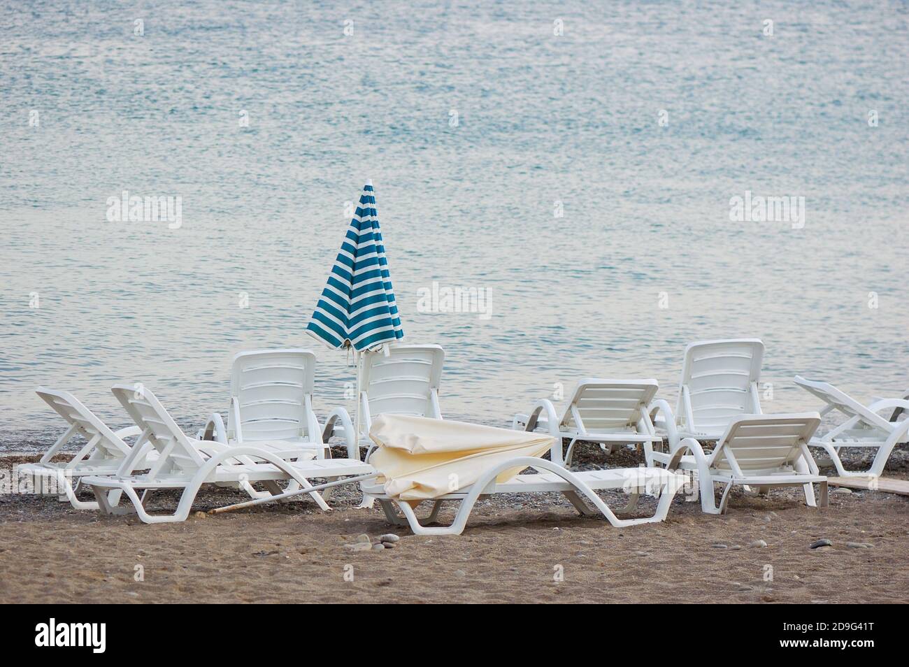 Sea coast with a beach, umbrellas and chaise lounges Stock Photo