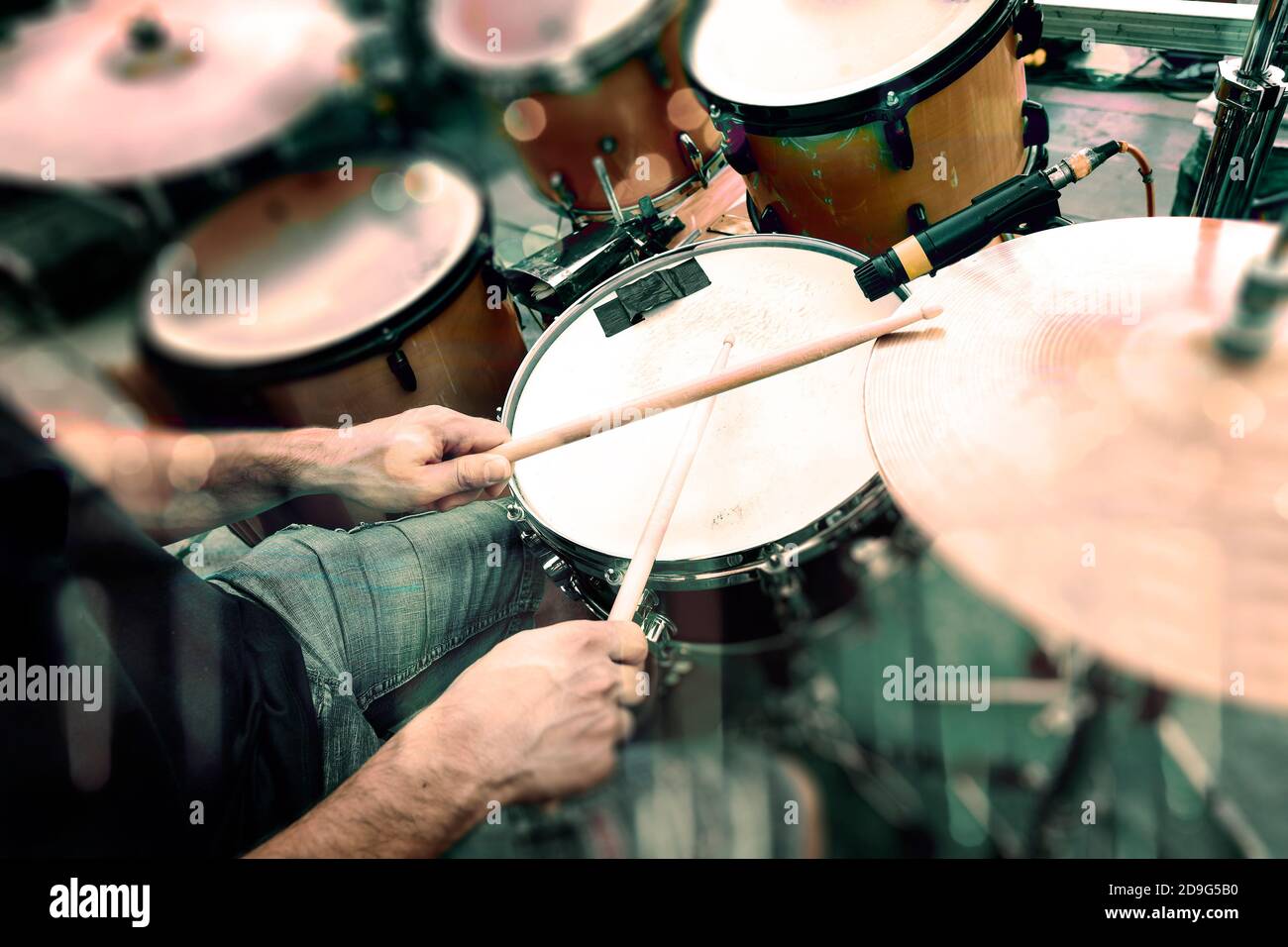 Drummer in concert playing drums in stage.Music band and live music background Stock Photo