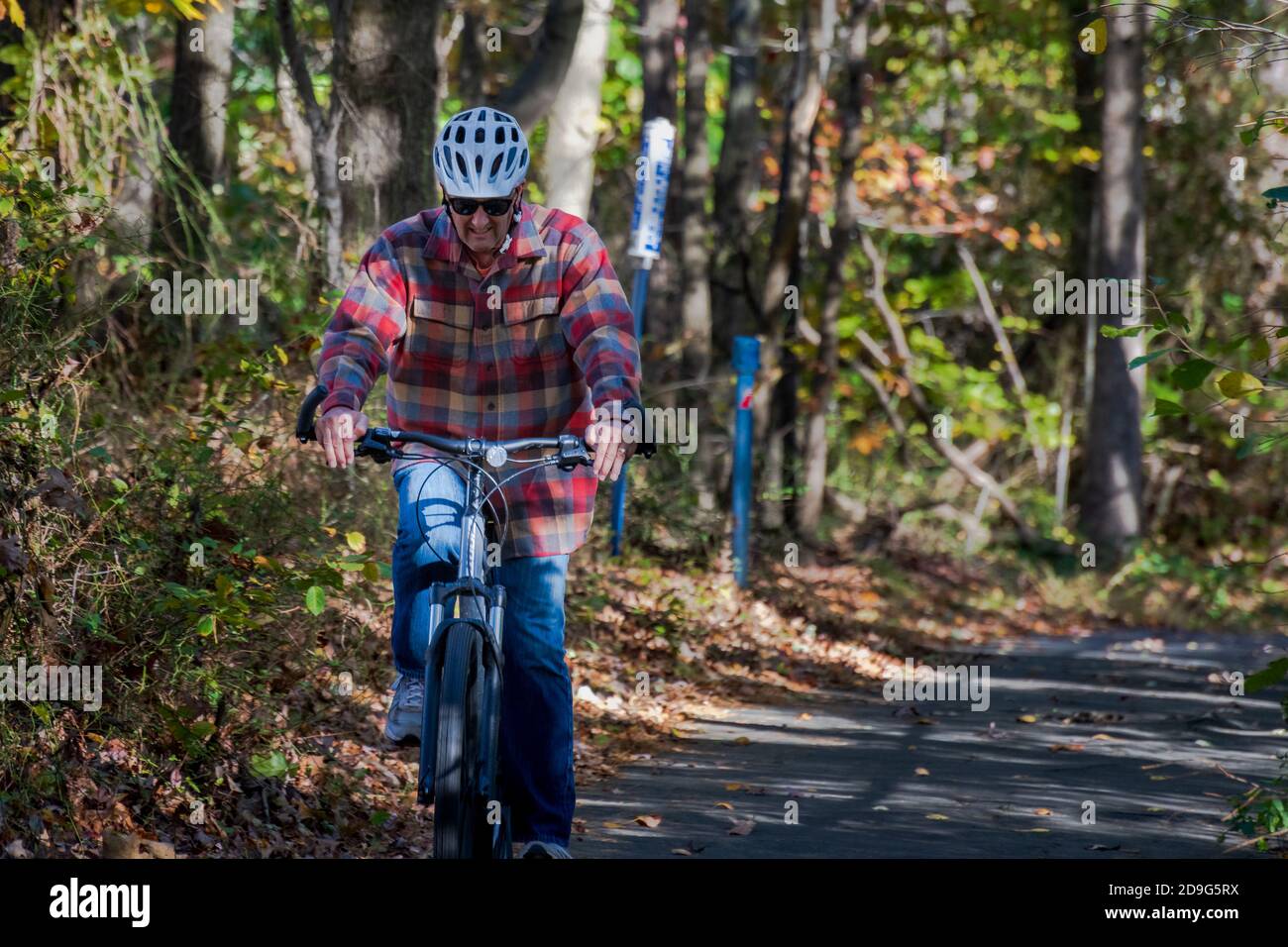 Helmeted man riding bicycle hi-res stock photography and images - Alamy