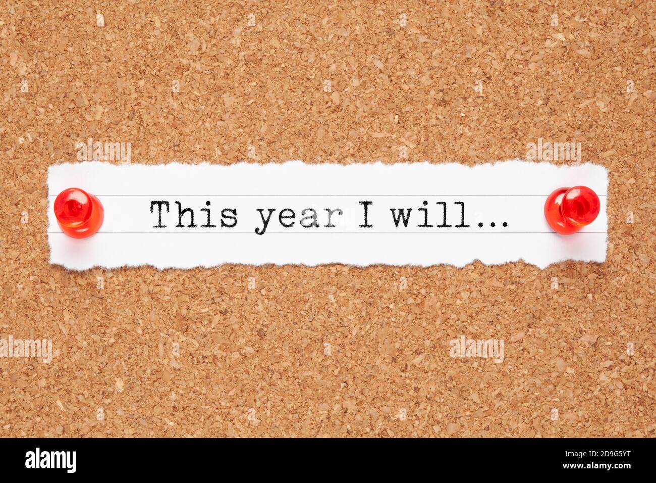 Inspirational text This Year I Will typed on a piece of white paper pinned on cork bulletin board. Motivational New Year resolutions concept. Stock Photo