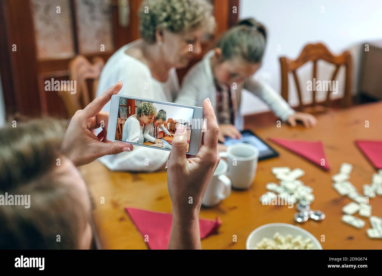 Grandmother and granddaughter play a game on the tablet Stock Photo