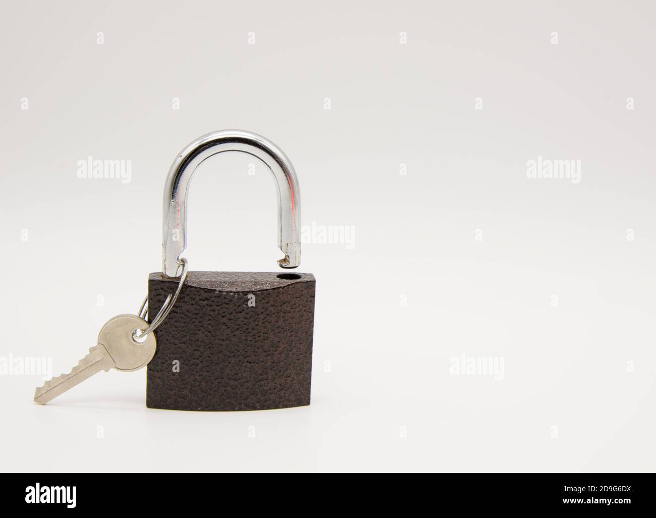 Metal padlock with key on white background Stock Photo - Alamy