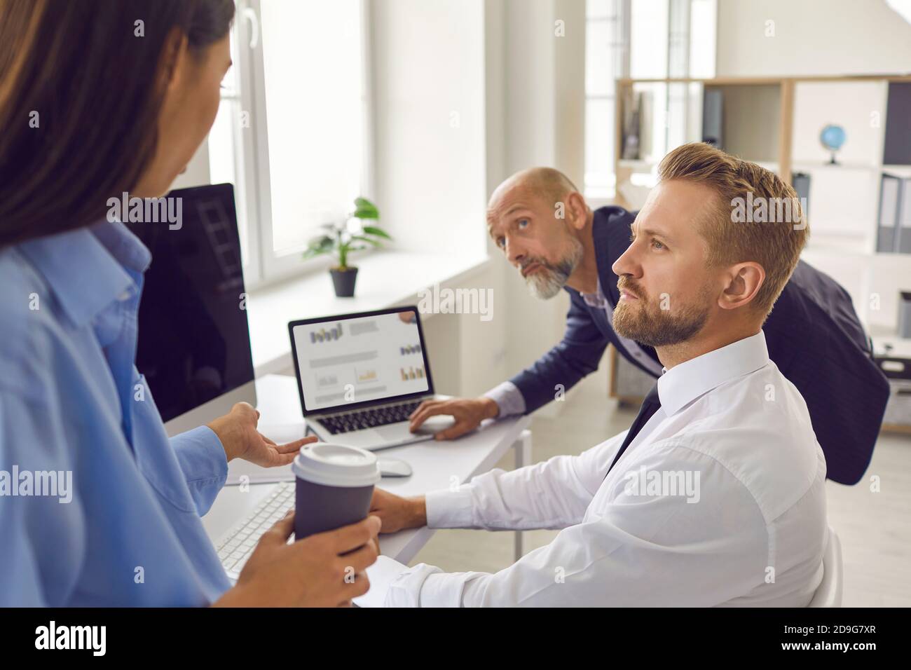Team of business people having discussion while analyzing statistics graphs and charts in office Stock Photo