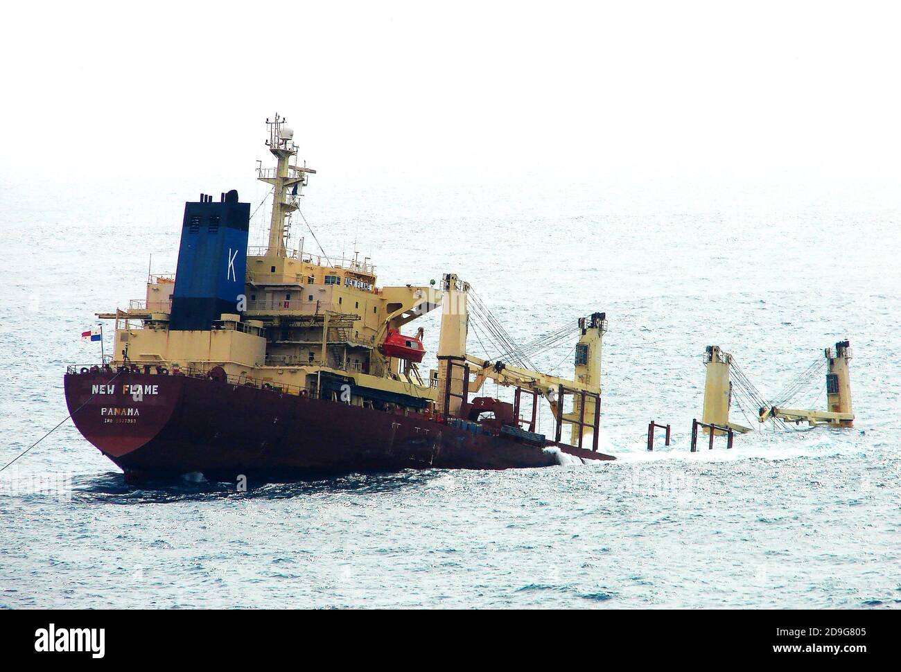 2007 photograph  -Wreck of the Panama Registered  MV NEW FLAME  lying half sunk off  Europa Point  Lighthouse, Gibraltar   -- The  Panamanian bulk-carrier cargo ship collided with  the   stern of the Torm Gertrud,a double-hulled Danish petroleum tanker on 12 August 2007. She ended up partially submerged in the Strait of Gibraltar, breaking  in two in December 2007 and couldn't be recovered. The cargo was salvaged and the stern section removed for scrap.  The Captain was arrested for departing without permission. It was built in 1994 &originally named Skaustrand. Stock Photo