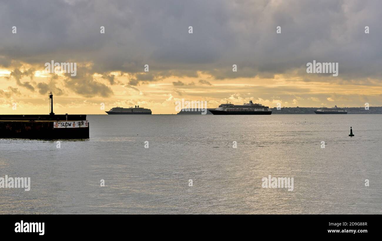 Cruise ships anchored in Tor Bay during the coronavirus pandemic, under threatening skies. Stock Photo