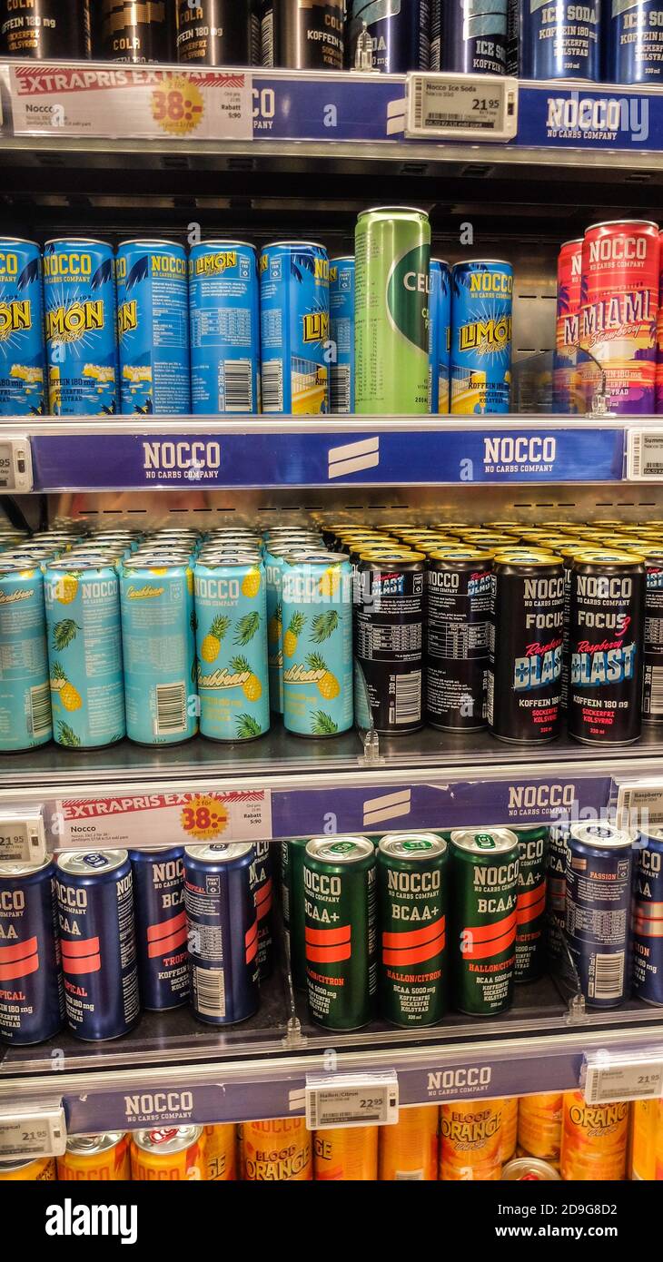 Large choice of canned energy drinks in a fridge in a Swedish grocery
