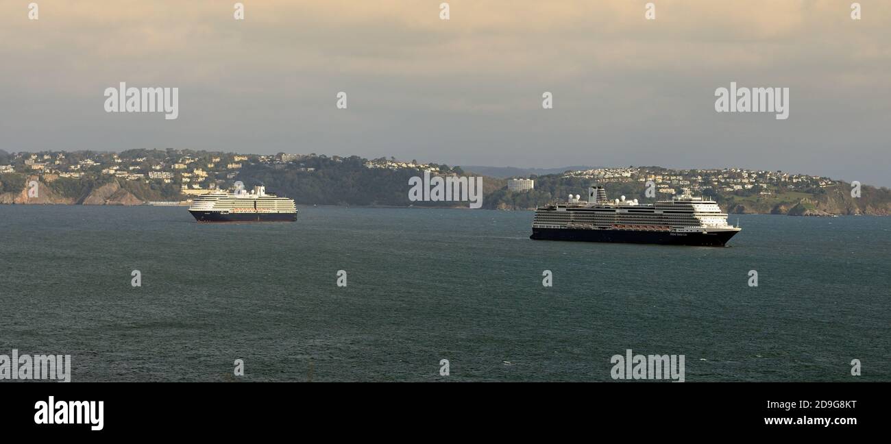Two Holland America Line cruise ships anchored in Tor Bay during the coronavirus pandemic, looking towards Torquay from Berry Head. Stock Photo