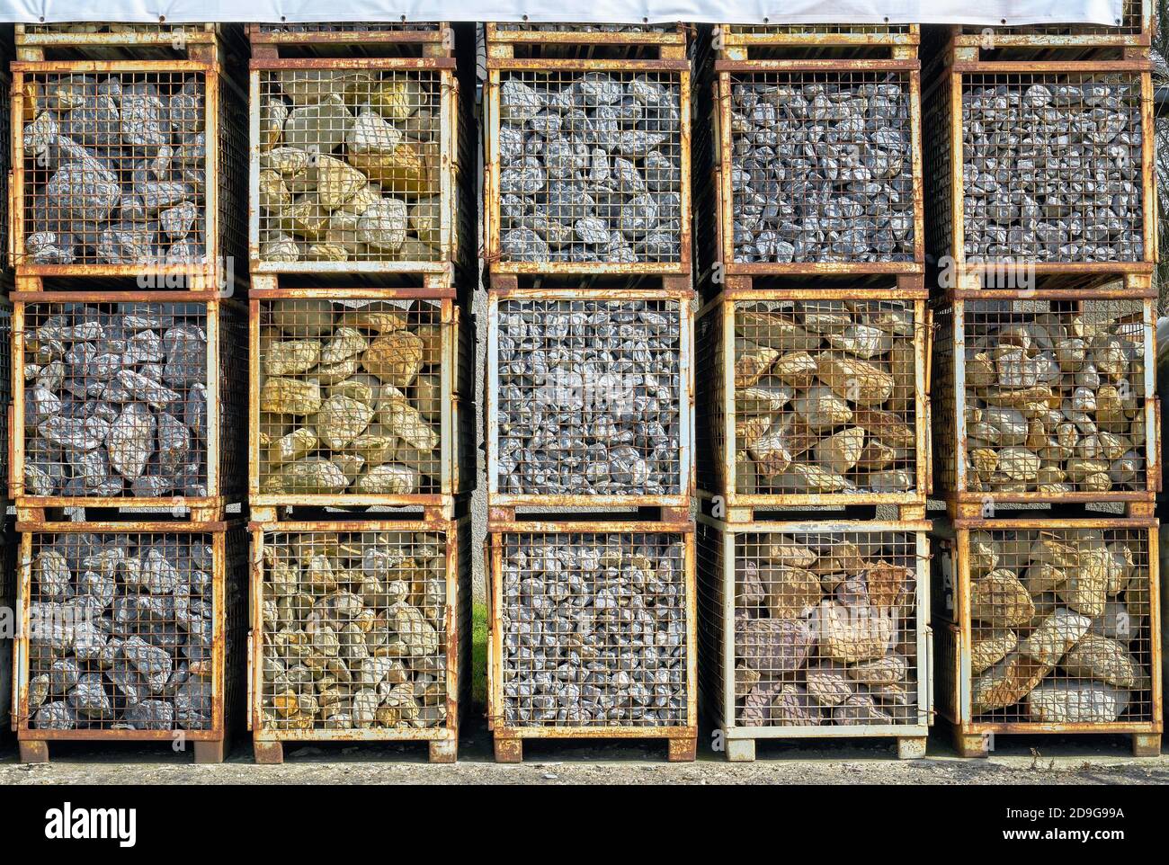 Natural stones in metal lattice transportation boxes Stock Photo