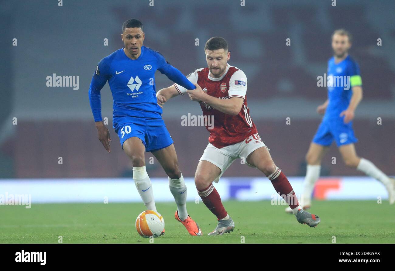 Molde's Mathis Bolly (left) and Arsenal's Shkodran Mustafi battle for the ball during the UEFA Europa League Group B match at the Emirates Stadium, London. Stock Photo