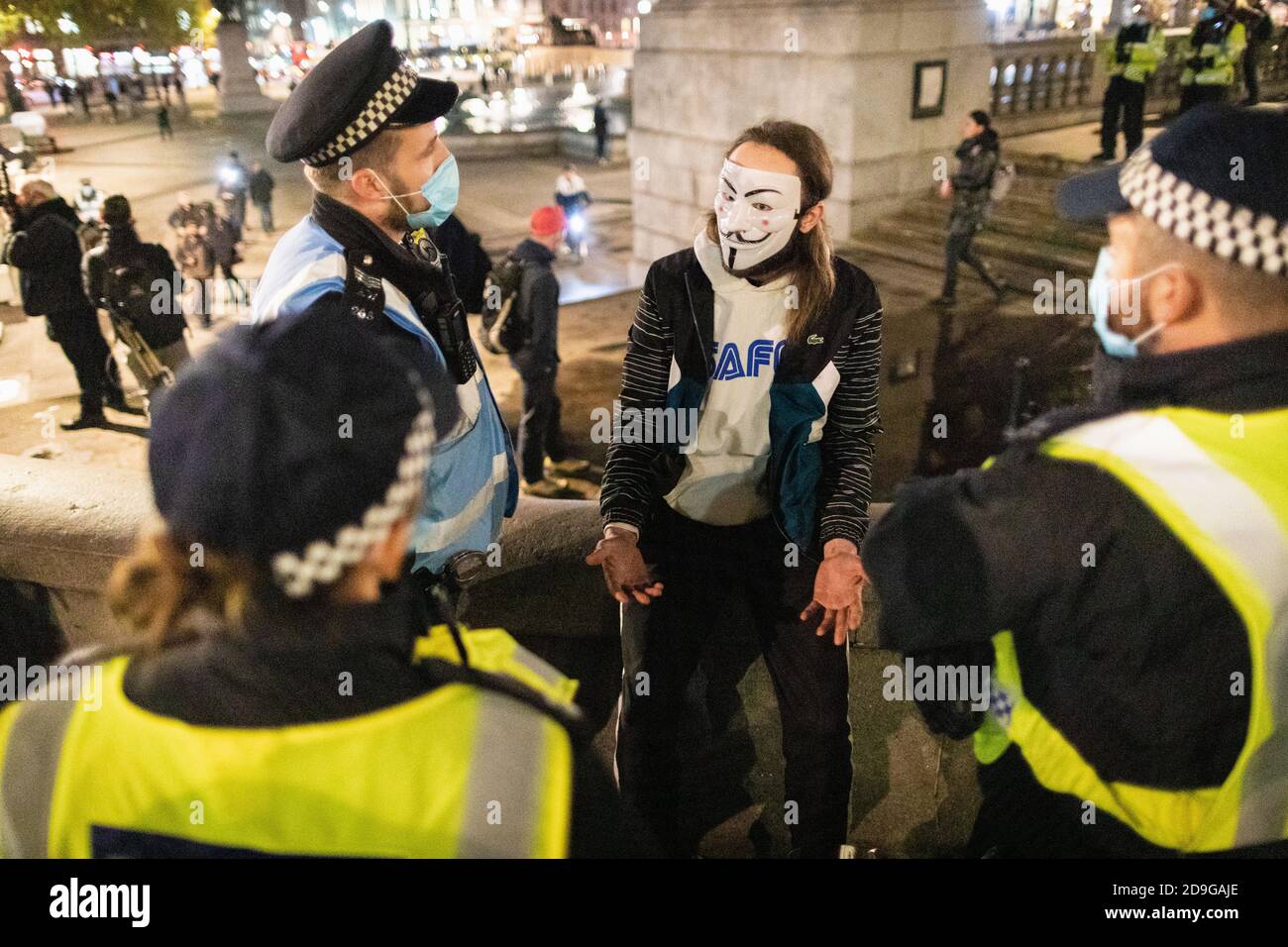 London, UK. 05th Nov, 2020. Police speak to a protester about social distancing at Trafalgar Square. The Expect Us movement partakes in their annual Million Mask March. The Anonymous movement shows solidarity for a society which is marginalised by the political elite and associated corporations. Credit: Andy Barton/Alamy Live News Stock Photo