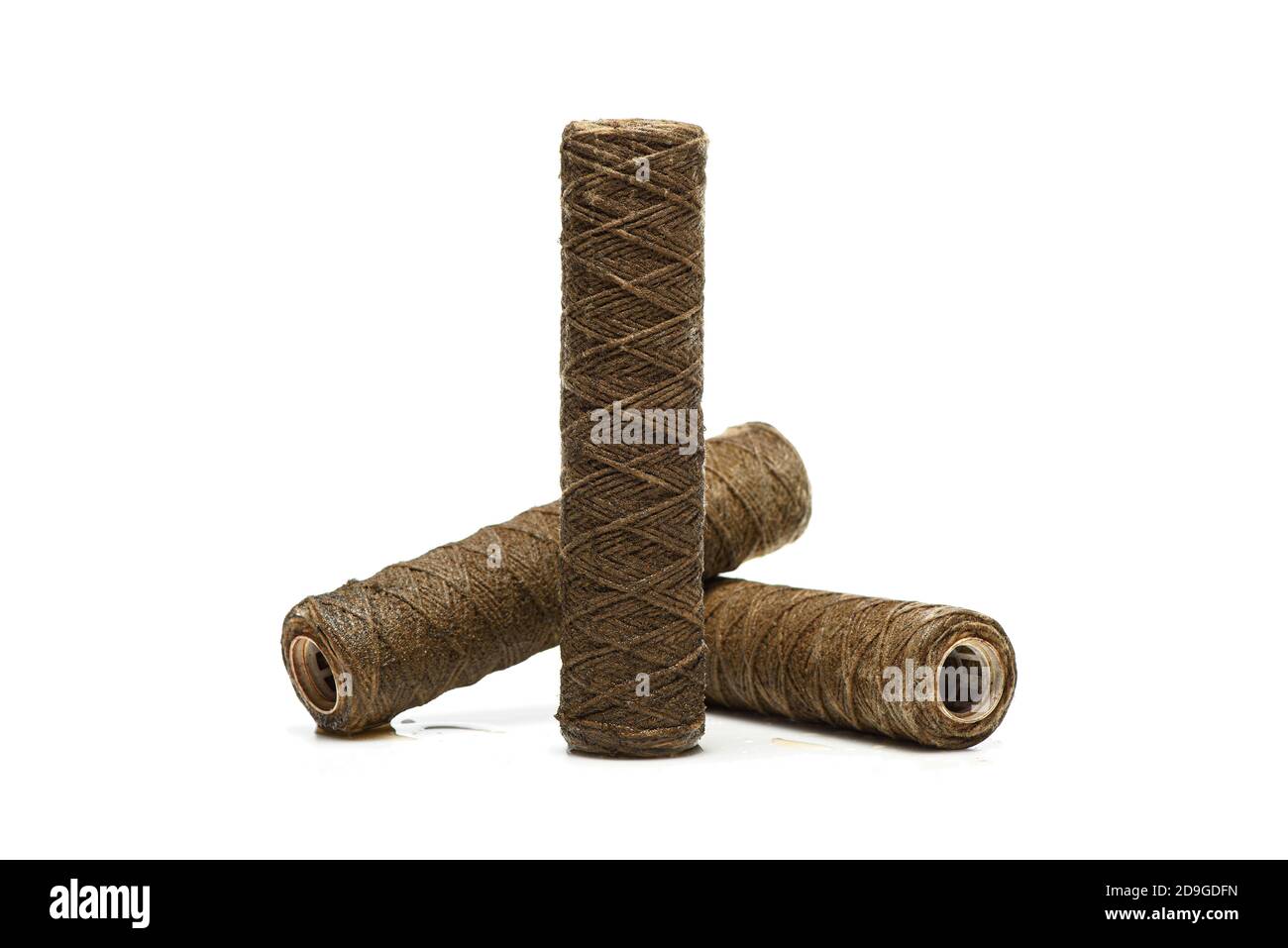 Three used rope water filters on white, studio shot. Clogged and dirty string water filters Stock Photo