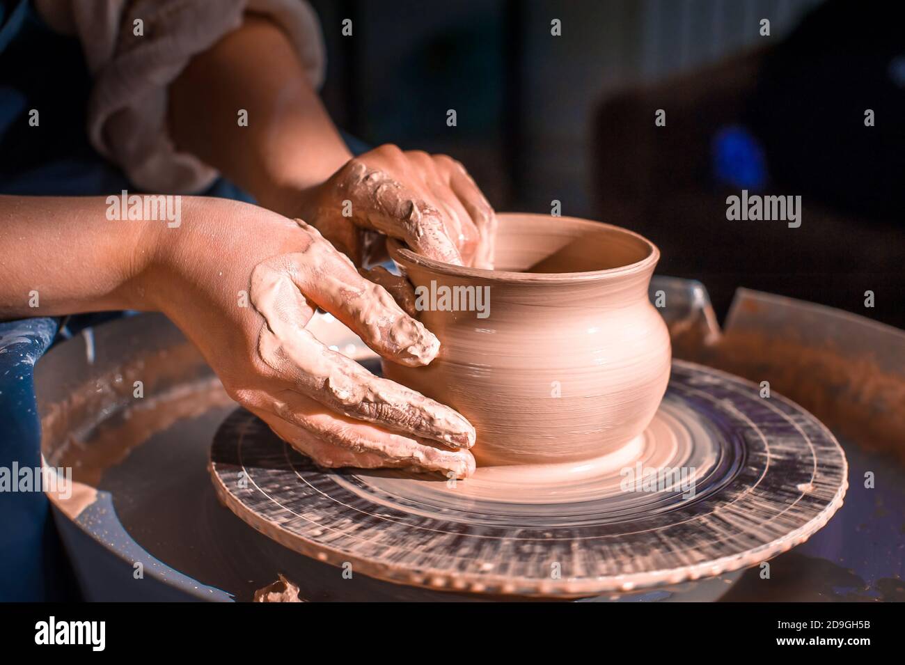 production process of pottery. Forming a clay teapot on a potter's