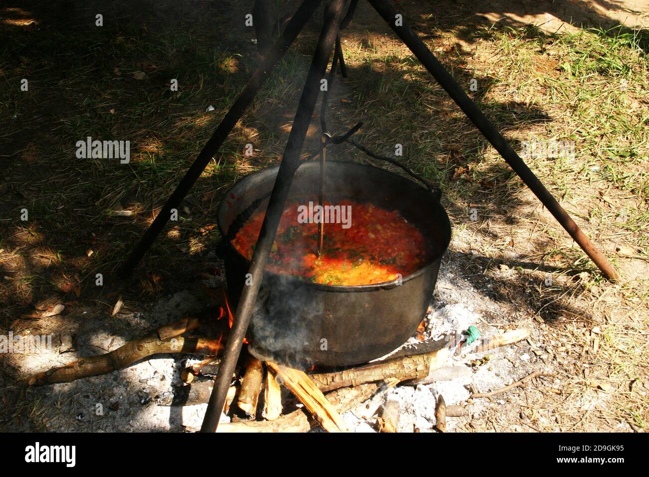 Cooking soup in cast iron boiler on burning campfire. Pot with soup over  the open fire outdoors. Tourism in Latvia. Cooking soup in a pot on  campfire Stock Photo - Alamy