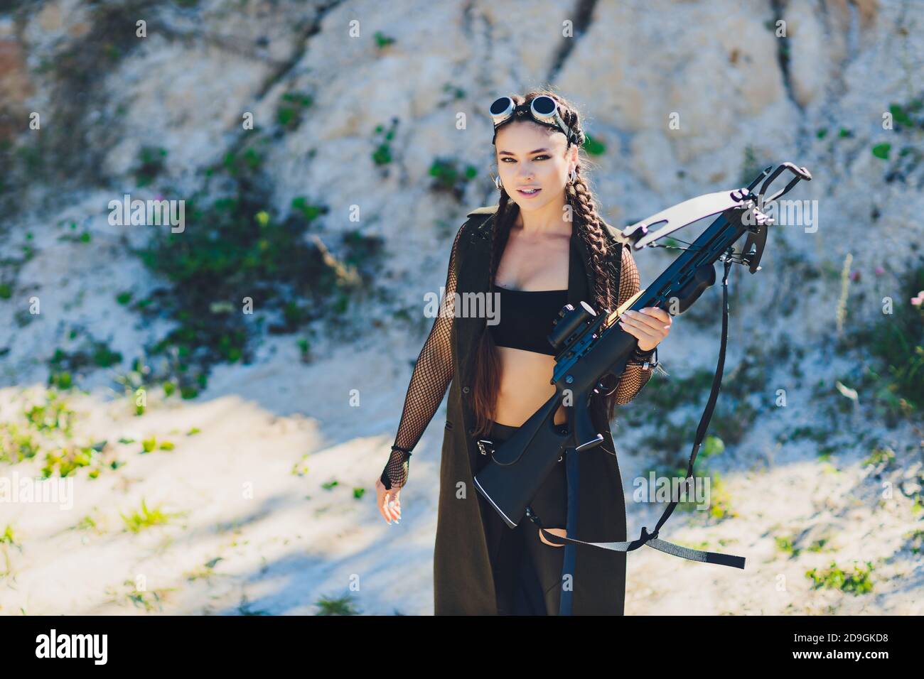 Athlete aiming Young woman holding the crossbow Stock Photo - Alamy