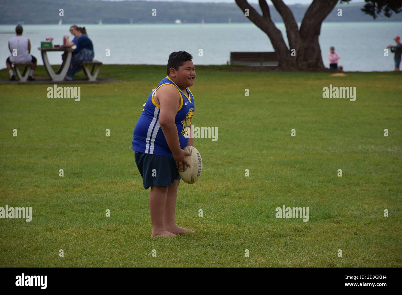 AUCKLAND, NEW ZEALAND - Nov 01, 2020: View of boy playing with rugby ball at  Mission Bay Stock Photo