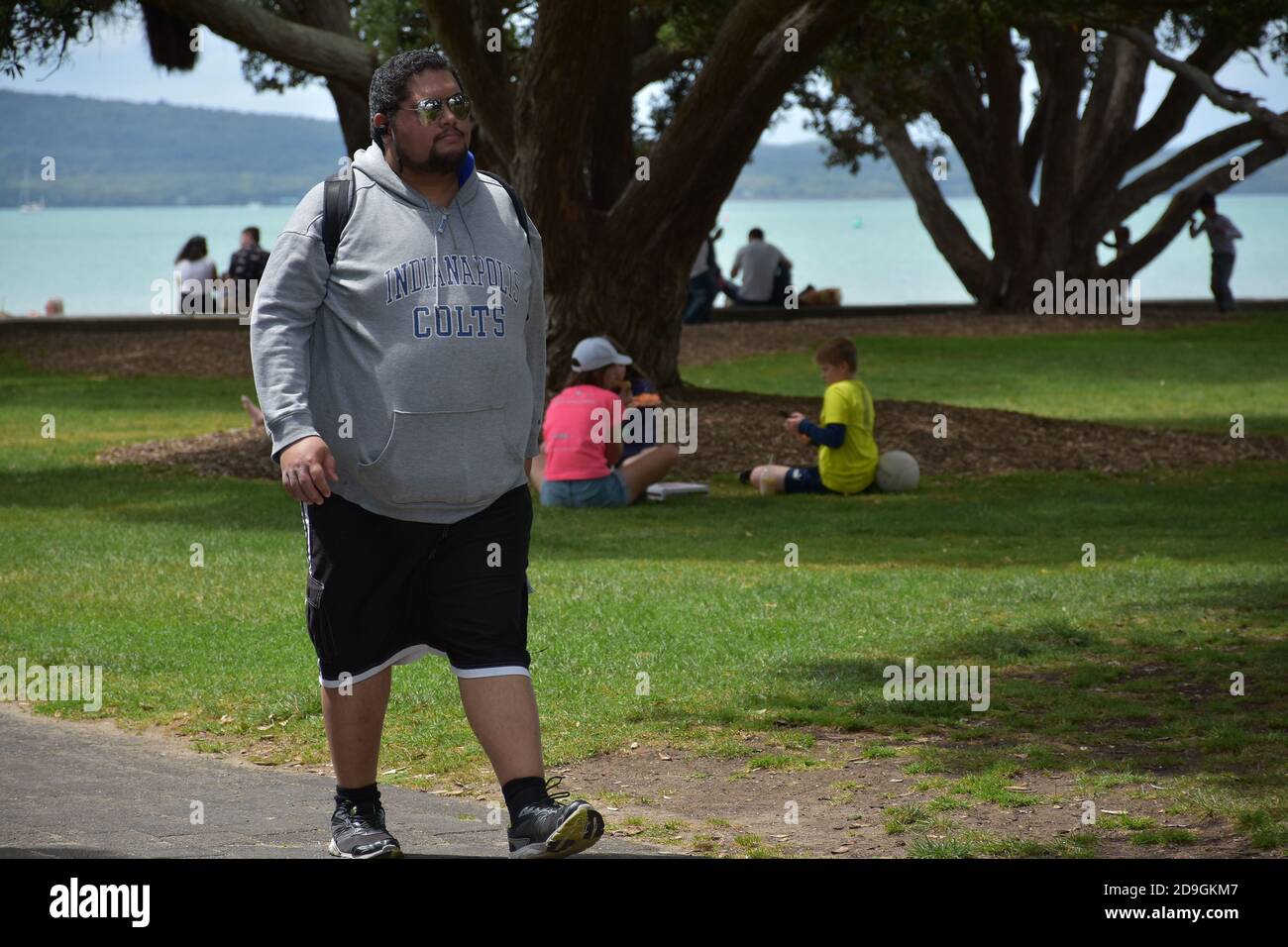 AUCKLAND, NEW ZEALAND - Nov 01, 2020: View of man walking on path in park at Mission Bay Beach Stock Photo