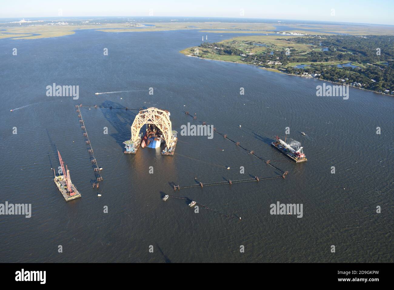 Workers install Environmental Protection Barriers around the Golden Ray