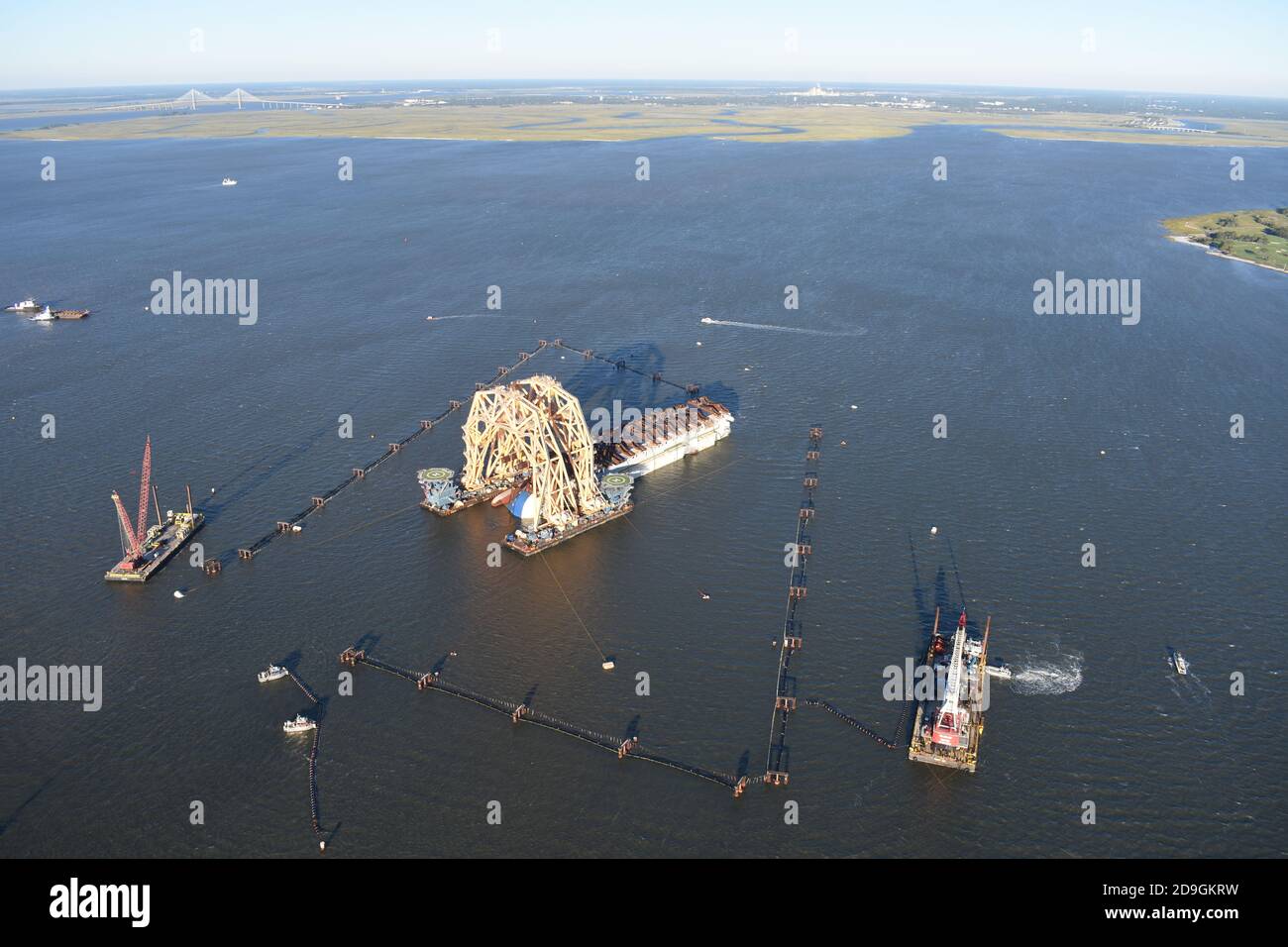 Workers install Environmental Protection Barriers around the Golden Ray