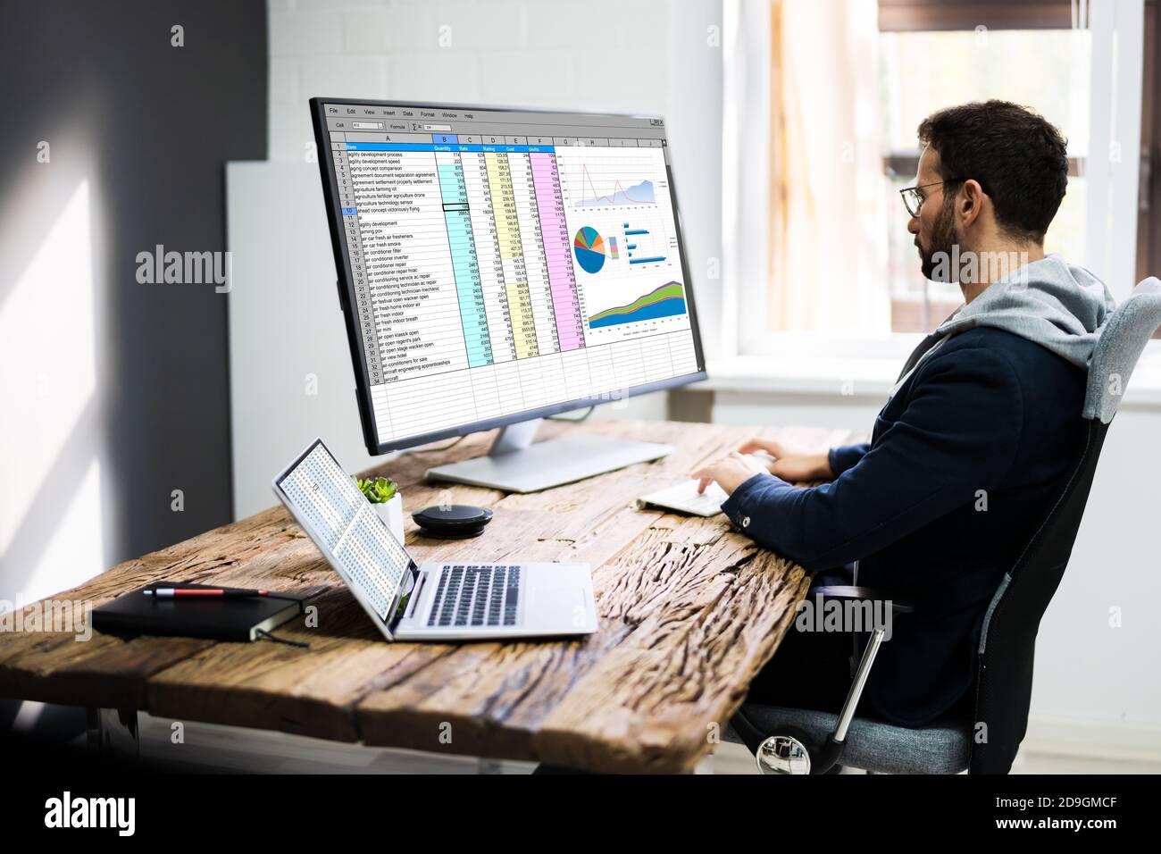 Analyst Employee Using Spreadsheet On Computer Screen Stock Photo