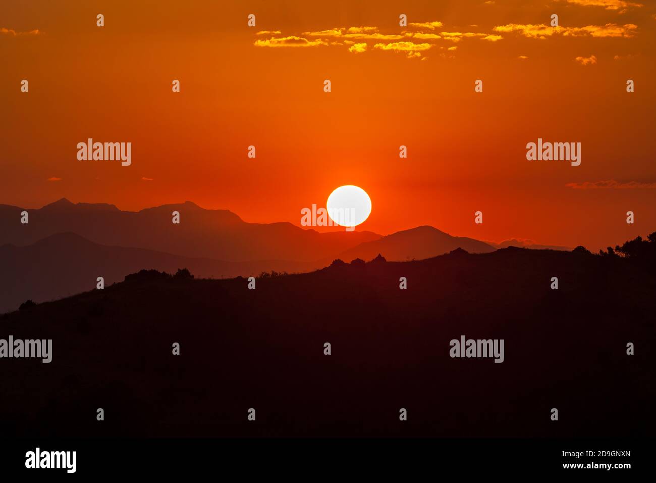 Fiery sunset over the mountains Stock Photo