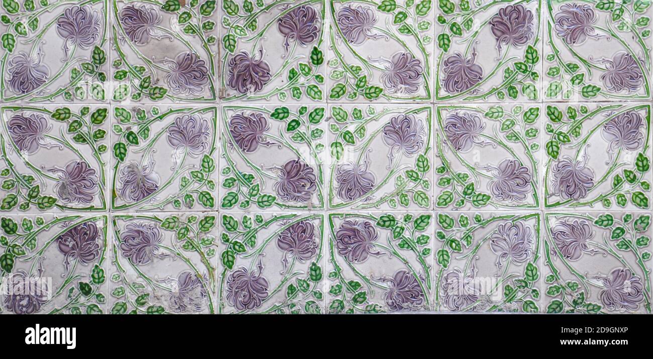 A mosaic of Green and lilac floral pernanakan tiles, as typically found on the frontage of traditional Chinese shop houses. Stock Photo