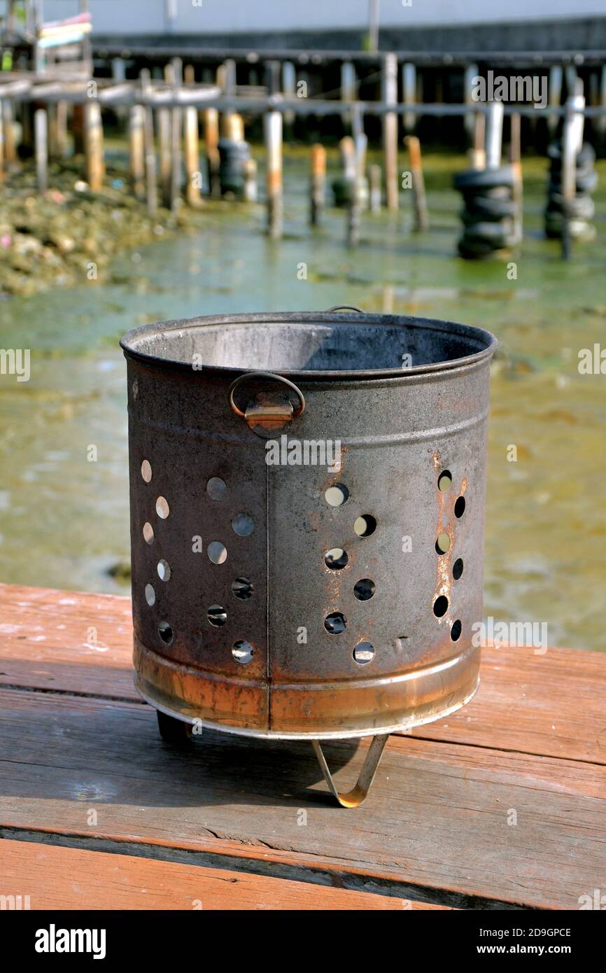 Iron bin used for the ceremonial burning of offerings by Chinese Buddhists. Stock Photo
