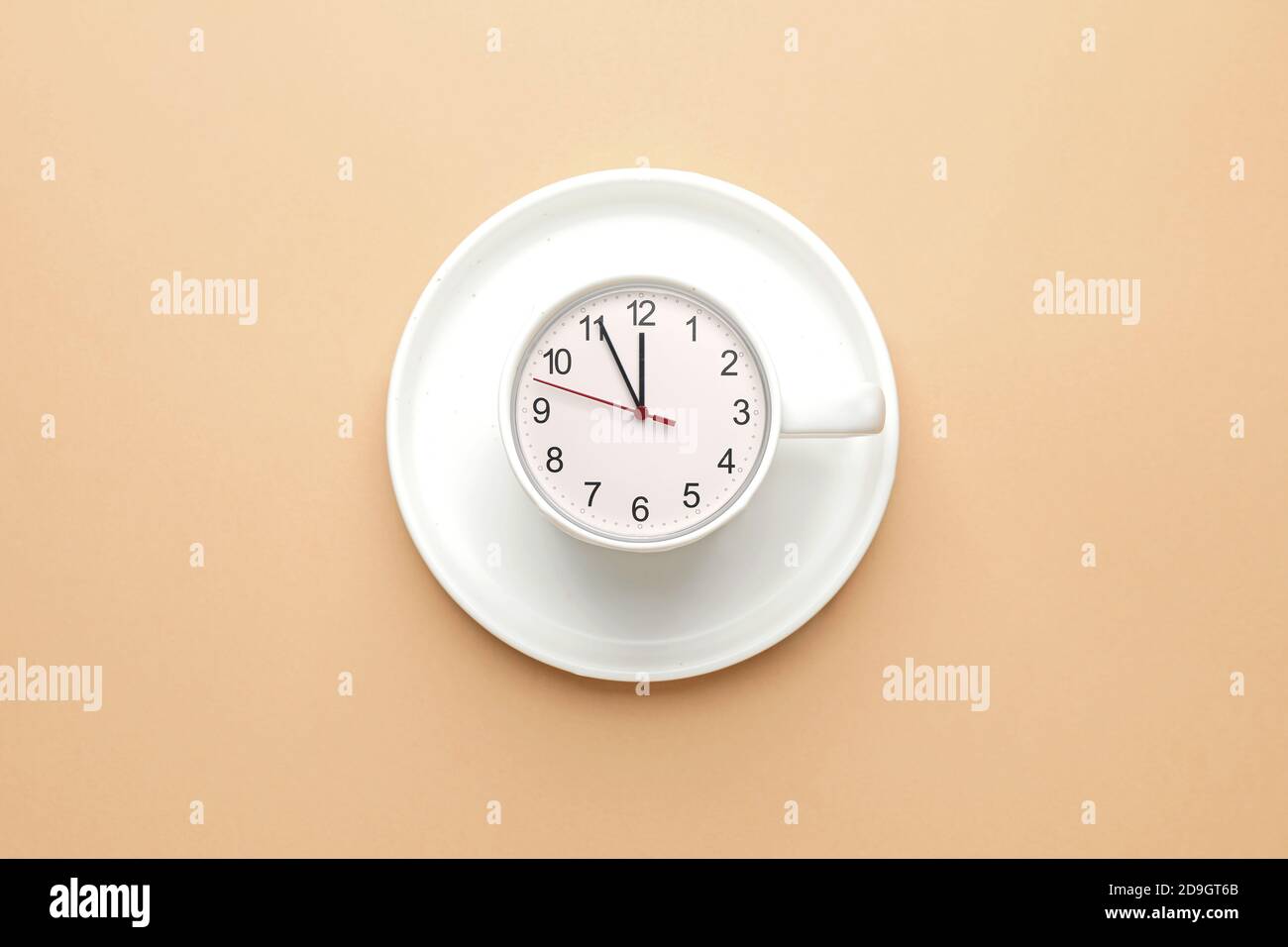 Cup with clock on color background Stock Photo