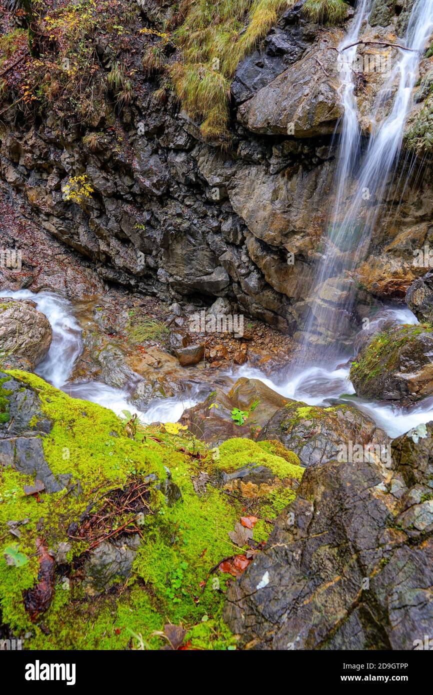 Beautiful view of tiny waterfall water flowing through the rocks ...